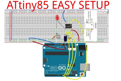 Układ ATtiny85 na płytce stykowej, podłączony do Arduino Uno. Widoczny rezystor, kondensator i dioda LED.