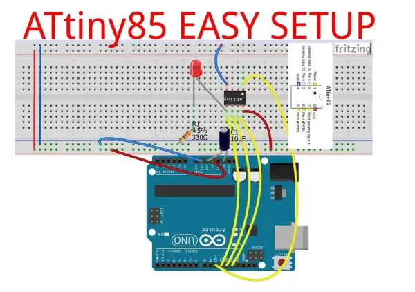 Układ ATtiny85 na płytce stykowej, podłączony do Arduino Uno. Widoczny rezystor, kondensator i dioda LED.